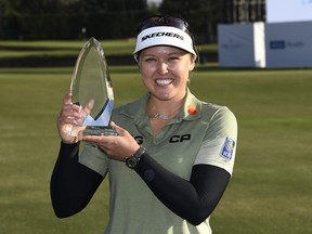 Canadian Brooke Henderson holds the trophy after winning the HUGEL-AIR PREMIA LA Open at Wilshire Country Club in Los Angeles on Saturday.