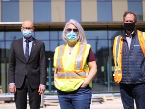 Fred Meier, president and CEO of Red River College (right), Maria Mendes, director of capital projects at Red River College (middle) and Frank Koreman, project manager with Akman Construction, gather outside the RRC Innovation Centre, which is still under construction, on Thursday. James Snell/Postmedia