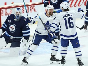 Toronto Maple Leafs forward Nick Foligno (centre) congratulates Mitch Marner on his goal last night.  KEVIN KING/Winnipeg Sun