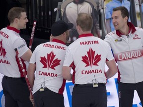 Team Canada players celebrate after defeating Scotland 9-6 in the first draw of the world men's curling championship in Calgary on April 2, 2021.