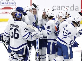 Toronto Maple Leafs players celebrate their overtime win over the Winnipeg Jets  at Bell MTS Place in Winnipeg on Friday, April 2, 2021.