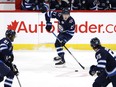 Winnipeg Jets left wing Nikolaj Ehlers (27) skates up the ice with teammates Winnipeg Jets left wing Kyle Connor (81) and Winnipeg Jets center Mark Scheifele (55) in the first period against the Toronto Maple Leafs at Bell MTS Place in Winnipeg on Friday, April 2, 2021.