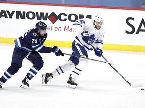 Toronto Maple Leafs Alex Galchenyuk (12) is chased down by Winnipeg Jets right wing Blake Wheeler (26) in the first period at Bell MTS Place in Winnipeg on Friday, April 2, 2021.