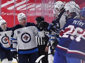 Pierre-Luc Dubois (13) of the Winnipeg Jets and Shea Weber (6) of the Montreal Canadiens skate against each other during the third period at the Bell Centre on Saturday in Montreal. Winnipeg Jets defeated the Montreal Canadiens 5-0.
