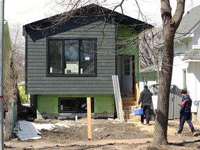 Workers arrive at an infill housing construction project in the St. James area of Winnipeg on Monday, April 19, 2021.