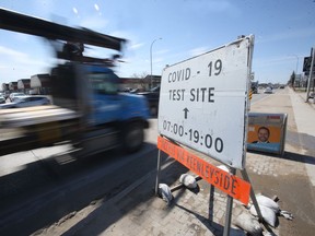 Vehicles pass a sign for a Covid-19 test site, in Winnipeg.   Wednesday, April 21, 2/2021.Winnipeg Sun/Chris Procaylo/stf