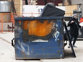 A fire-damaged garbage bin behind 33 Hargrave Street in Winnipeg on Sunday, April 25, 2021. Police are hoping to speak with a male and female who may have spoke to Chantelle Talarico, 30, before she was found in the bin on April 6 and succumbed to her injuries. Police do not believe the fire was intentionally set.
