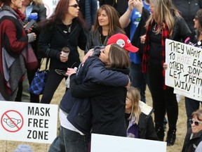 It was hugs over masks during an anti-mask rally at The Forks in Winnipeg on Sunday, April 25, 2021.