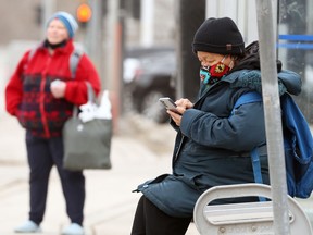 A woman in a colourful mask at an Osborne Village bus stop in Winnipeg on Monday, April 26, 2021.