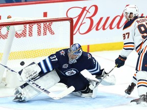 Winnipeg Jets goaltender Connor Hellebuyck is beaten on a breakaway by Edmonton Oilers centre Connor McDavid in Winnipeg on Mon., April 26, 2021. KEVIN KING/Winnipeg Sun/Postmedia Network