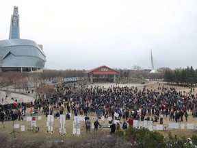 A wide shot of the crowd at an anti-mask rally at The Forks in Winnipeg on Sunday, April 25, 2021, taken from the roof of the parkade.