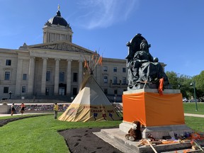 A memorial has taken shape on the footsteps of the Manitoba Legislature in Winnipeg on Monday, May 31, 2021, to remember the 215 children whose bodies were found in an unmarked grave at the Kamloops Indian Residential School in Kamloops, B.C., on Friday. Josh Aldrich/Winnipeg Sun