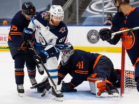 Goaltender Mike Smith (41) of the Edmonton Oilers makes a save against Kyle Connor (81) of the Winnipeg Jets during Game Two of the First Round of the 2021 Stanley Cup Playoffs at Rogers Place on May 21, 2021 in Edmonton.