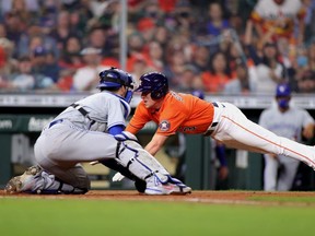 Myles Straw #3 of the Houston Astros is tagged out at home by Danny Jansen #9 of the Toronto Blue Jays during the sixth inning at Minute Maid Park on May 07, 2021 in Houston, Texas.