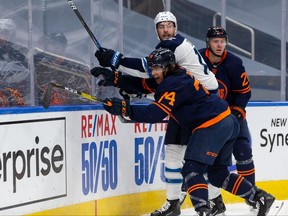 Edmonton Oilers’ Ethan Bear (74) battles Winnipeg Jets’ Pierre-Luc Dubois (13) during the second period of Game 2 of their NHL North Division playoff series at Rogers Place in Edmonton, on Friday, May 21, 2021.