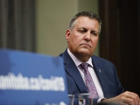 Manitoba Education Minister Cliff Cullen listens to a reporter's question at a COVID-19 press conference at the Manitoba Legislature in Winnipeg Sunday, May 9, 2021.