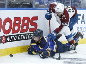 Patrik Nemeth, right, of the Colorado Avalanche scrambles for the puck against Zach Sanford of the St. Louis Blues in the second period at Enterprise Center on May 21, 2021 in St Louis, Miss.
