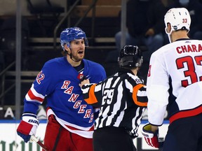 Brendan Smith of the New York Rangers chats with Zdeno Chara of the Washington Capitals on Wednesday.