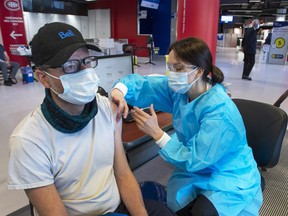 Nicholas Granger gets his COVID-19 vaccination at a clinic for company employees and their families at the Bell CentreThursday, May 6, 2021 in Montreal.