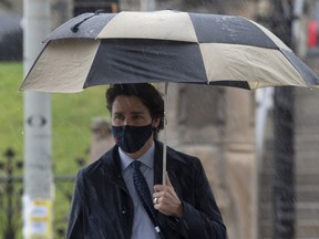 Prime Minister Justin Trudeau walks to a news conference in the Parliamentary precinct on a rainy day in Ottawa, Friday, April 30, 2021.