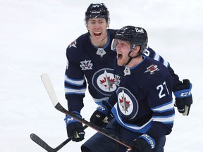 Winnipeg’s Nikolaj Ehlers (right) doesn’t hold back when his team scores in OT.  Getty Images
