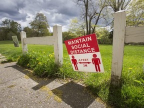 A sign warning people to stay physically distanced is seen at Flemingdon Park Golf Club in Toronto, May 10, 2021.