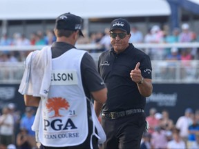 Phil Mickelson gives a thumbs-up to his caddie after playing a shot on to the 18th green during the third round of the PGA Championship at Kiawah Island Resort's Ocean Course on Saturday in Kiawah Island, S.C.