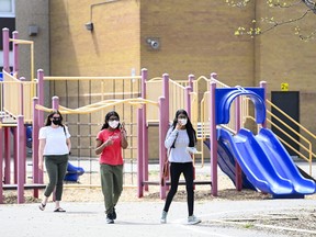 Families and youth aged 12 and older line up for a COVID-19 vaccine at Gordon A Brown Middle School in Toronto Wednesday May 19, 2021.