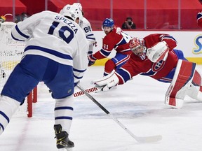 Montreal Canadiens goalie Carey Price dives for the puck on a shot from Toronto Maple Leafs forward Jason Spezza during their playoff game at the Bell Centre Monday night. USA TODAY SPORTS