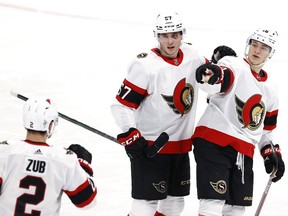 Ottawa Senators left wing Tim Stutzle (18) celebrates his first period goal with Ottawa Senators defenceman Artem Zub (2) and Ottawa Senators center Shane Pinto (57) against the Winnipeg Jets at Bell MTS Place in Winnipeg on Saturday, May 8, 2021.