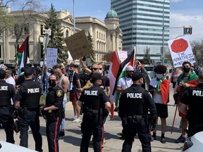 Supporters of Israel and Palestine clashed adjacent to the Manitoba Legislature on Saturday. Members of the Winnipeg Police Service separated the two groups. James Snell/Postmedia