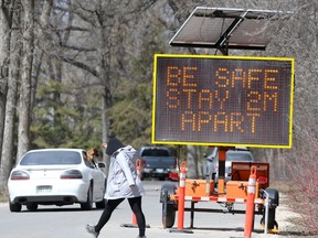A sign reminds people to remain distant in St.Vital Park.  Chris Procaylo/Winnipeg Sun