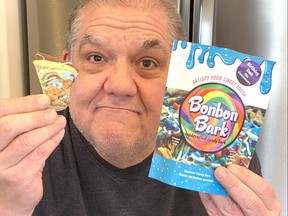 Hal Anderson holds a bag and a sample of Bonbon Bark.