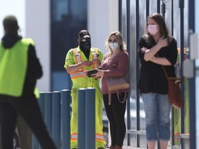 People line up to enter a vaccine clinic in Winnipeg on Tuesday, May 11, 2021.