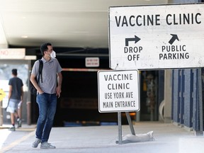 A man wearing a mask seeking direction outside the COVID-19 vaccination site at RBC Convention Centre in Winnipeg on Sunday, May 16, 2021.