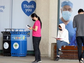 People wait outside the COVID-19 vaccination site at RBC Convention Centre in Winnipeg on Sun., May 16, 2021. KEVIN KING/Winnipeg Sun/Postmedia