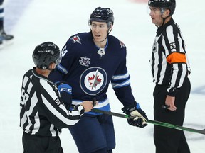 Winnipeg Jets defenceman Logan Stanley jaws with Edmonton Oilers forward Josh Archibald after his low hit in Game 3 of a Stanley Cup playoff series in Winnipeg on Sunday, May 23, 2021.