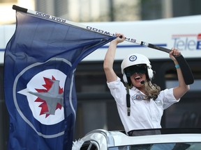 Winnipeg Jets fans take part in a honk parade prior to Game 4 of the Stanley Cup playoff series against the Edmonton Oilers, in Winnipeg on Monday. A honk parade was also held before Sunday's Game 3 5-4 Jets' overtime victory.