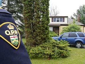 Prince Edward County OPP Sgt. Sean Guscott stands outside a home east of Rossmore Friday afternoon. Police said they arrested Manitoba homicide suspect Eric Wildman, 34, and another person earlier in the day after taking gunfire while conducting a search warrant at the home Thursday night.