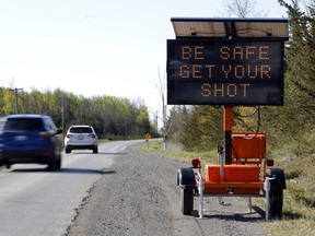 A sign promotes COVID-19 vaccination Wednesday, May 12, 2021 north of Shannonville, Ont.