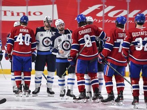 The Winnipeg Jets and the Montreal Canadiens shake hands following the Canadiens 3-2 overtime victory to close out the series in Game Four of the Second Round of the 2021 Stanley Cup Playoffs at the Bell Centre on June 7, 2021 in Montreal, Canada.  The Montreal Canadiens defeated the Winnipeg Jets 3-2 in overtime and eliminated them with a 4-0 series win. (Photo by Minas Panagiotakis/Getty Images)