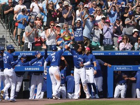 Blue Jays' Joe Panik celebrates his three-run home run with teammates during the fourth inning against the Houston Astros at Sahlen Field.