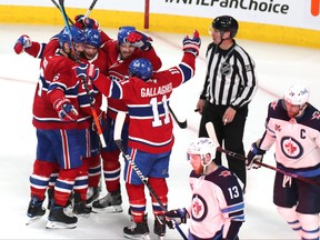 Montreal Canadiens left winger Artturi Lehkonen (62) celebrates his goal against Winnipeg Jets with teammates during the second period in Game 3 in Montreal last night.