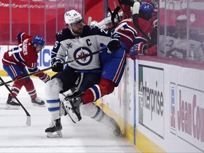 Jets forward Blake Wheeler (left) hits Canadiens’ Ben Chiarot during Game 4. Wheeler has three more years remaining on his contract.