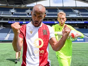 Valour FC's Andy Baquero and goalkeeper Jonathan Sirois celebrate a 2-0 victory over Forge FC at IG Field in Winnipeg on Sunday, June 27, 2021.