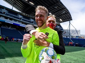 Valour FC Head Coach Rob Gale celebrates with goalkeeper Jonathan Sirois following a 2-0 victory over Forge FC at IG Field in Winnipeg on Sunday, June 27, 2021.