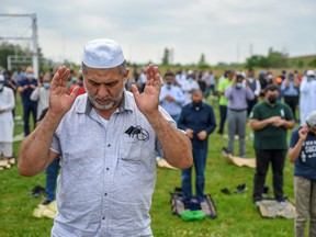 Mourners pray at the funeral of the Afzaal family that was killed in London.