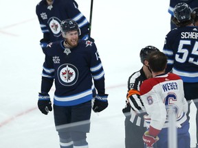 Winnipeg Jets centre Pierre-Luc Dubois (left) yells at Shea Weber as Montreal Canadiens defenceman looks for a piece of Jets centre Mark Scheifele during Game 1 of their division final.