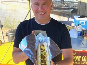 Pony Corral owner Peter Ginakes set up a mobile barbeque (it's built to look like an antique car) in front of his Pier 7 location on Pembina Highway in Winnipeg. He's serving up hamburgers, hot dogs, smokies and cold beverages. Customers don't even have to get out of their vehicles because Peter has brought back carhops, reports Hal's Kitchen columnist Hal Anderson. Servers come right to your car window, take your order and then bring it to you when it's ready.