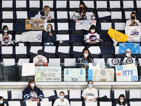 Front-line workers at Bell MTS Place await the start of Game 1 of the North Division final between the Winnipeg Jets and Montreal Canadiens in Winnipeg on June 2, 2021.